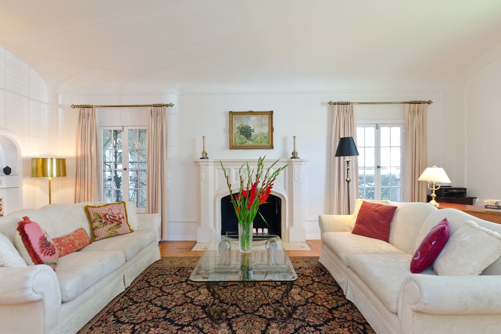 Relax in the living room with 2 comfortable sofas, beautiful fireplace and mantle.