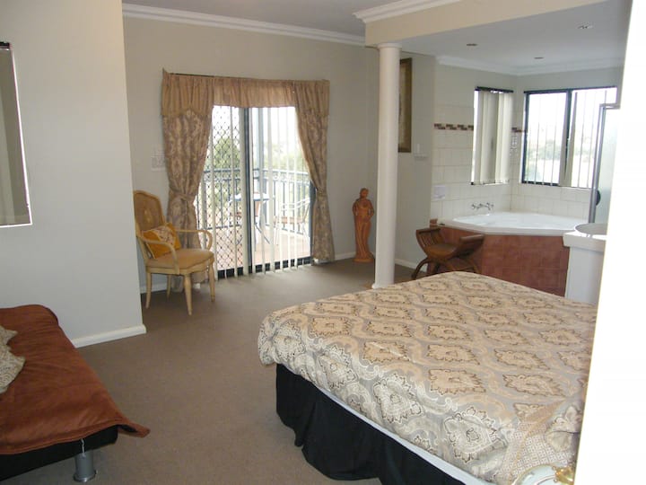 Main Queen size bedroom with own spa in the ensuite and private balcony