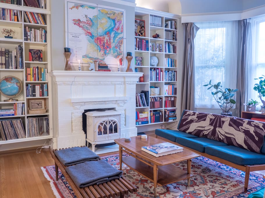 The sitting room has vintage mid-century modern furnishings and an ultra cozy gas fireplace.