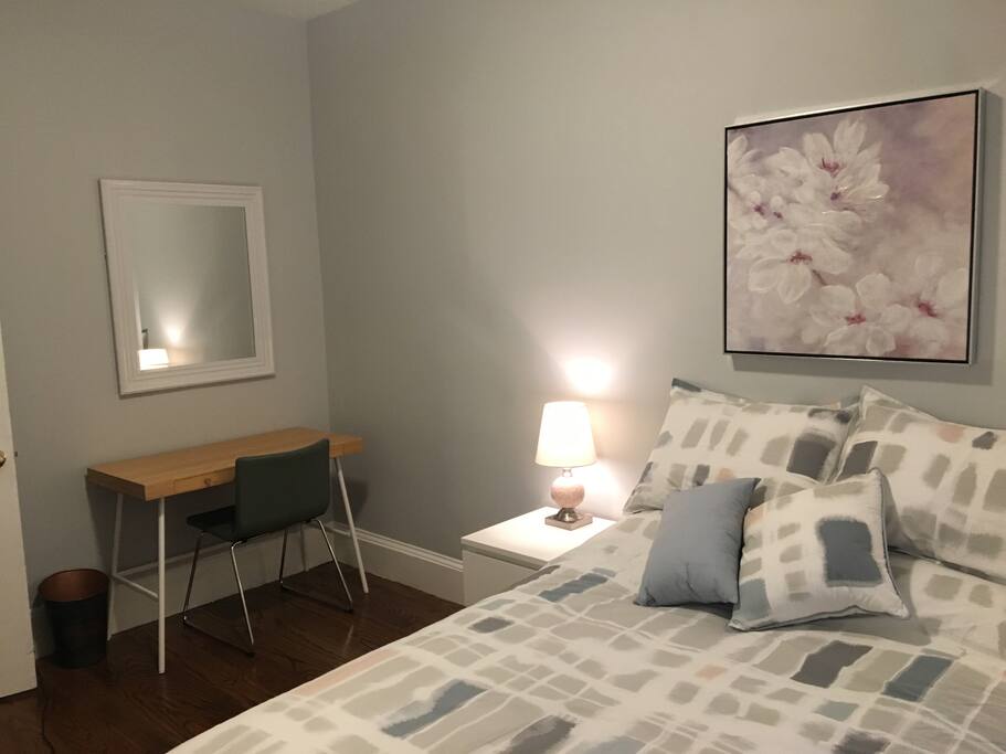 Small desk with comfortable chair provided as a work space, eating table, or simply a surface to place your things. Portrait-size mirror included for your convenience.