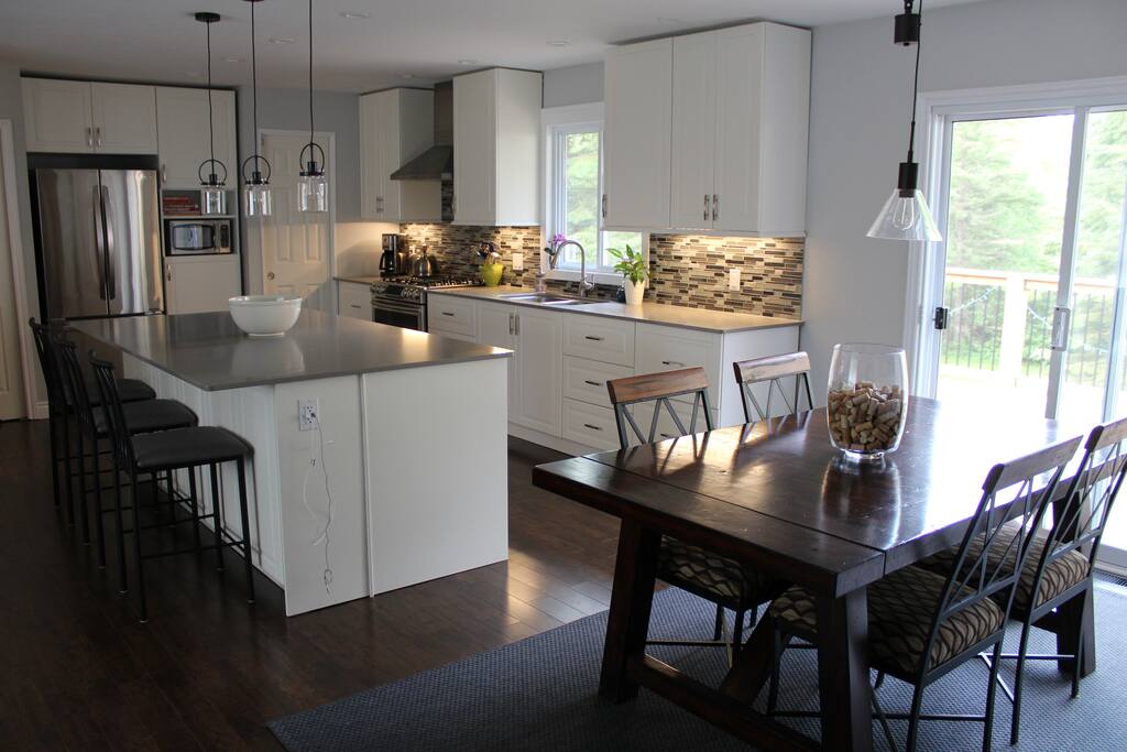 Open concept kitchen/dining room with sliding door to deck