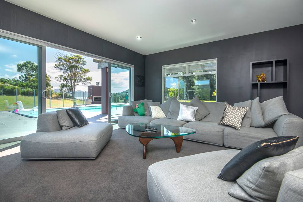 Comfy second lounge room with 65" tv and gas fire.