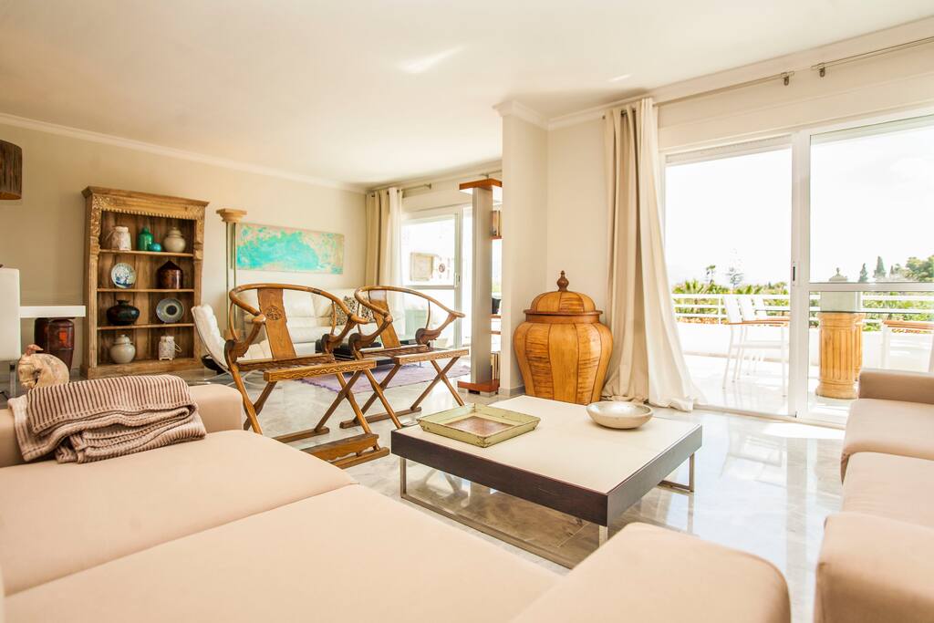 Giant living room with 2 different areas: 3 comfy sofas, TV and indoor dining table
