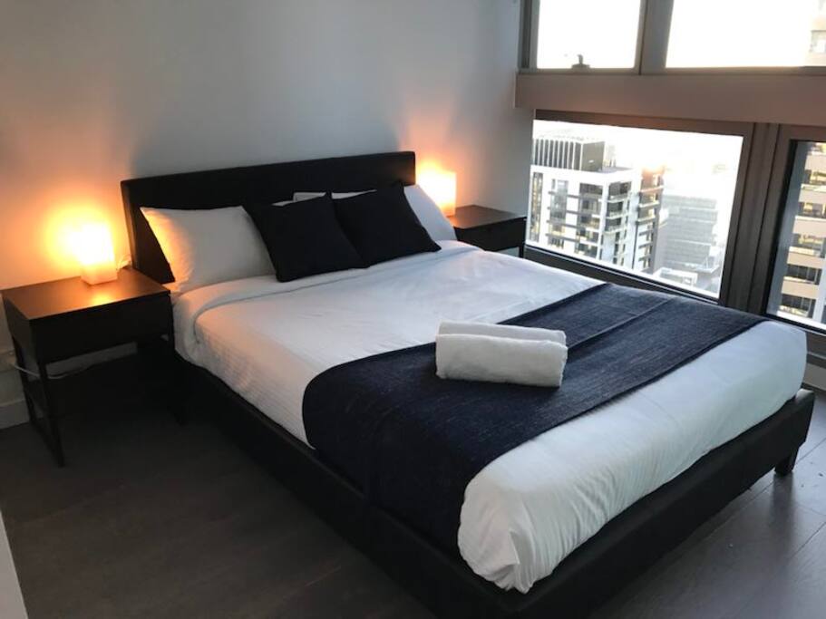 A bedroom with french casement, port Melbourne is visible clearly from up here.