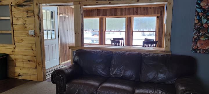 Living room view of dining area and front entry door. 