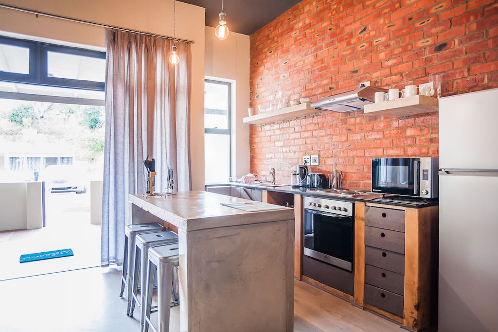 Fully equipped kitchen with hob, stove, kettle, microwave, toaster and fridge