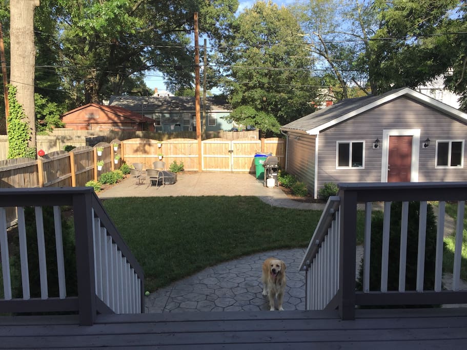 Beautiful fenced-in backyard with concrete patio, fire-pit, grill, and spacious deck.