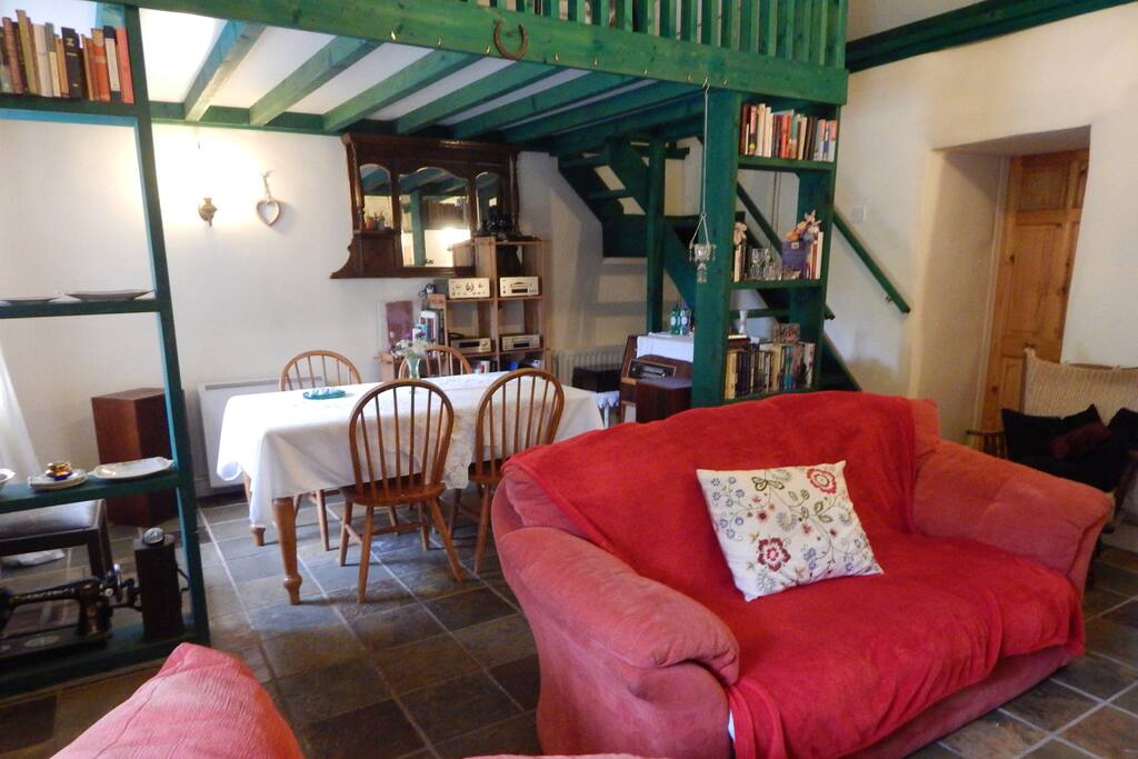 Your private living space with sitting and table area, plus stairs to bed area on the balcony.