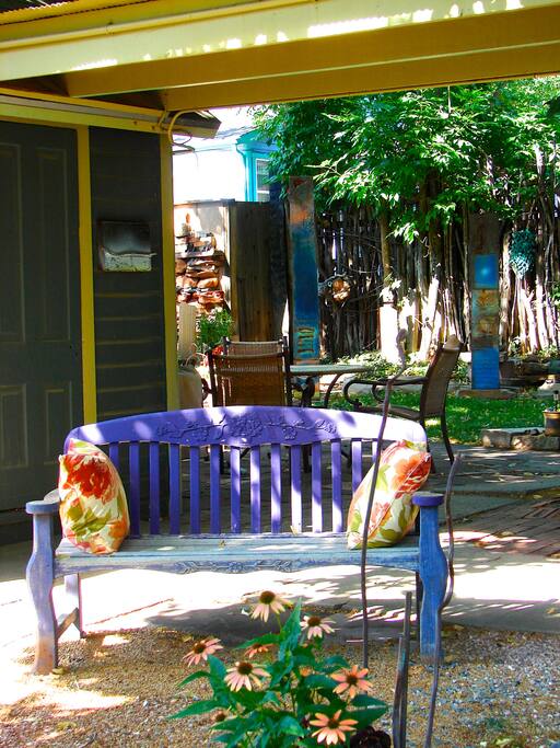 garden courtyard behind purple bench