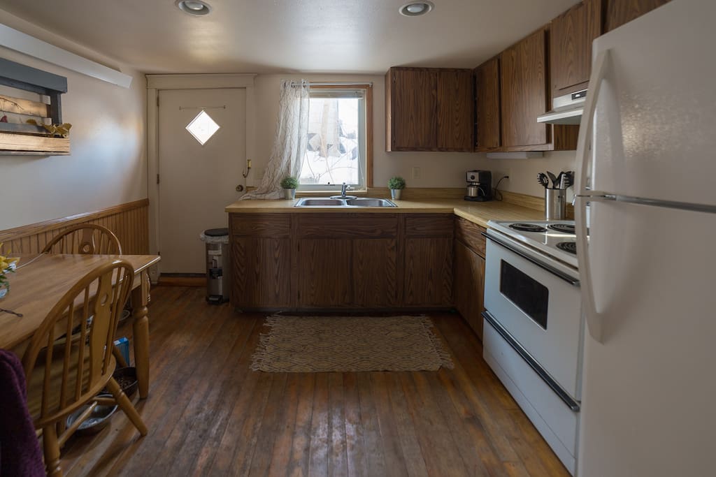 Full kitchen with table and back door