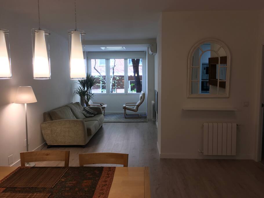 Living room, with large window to the tree-covered street.