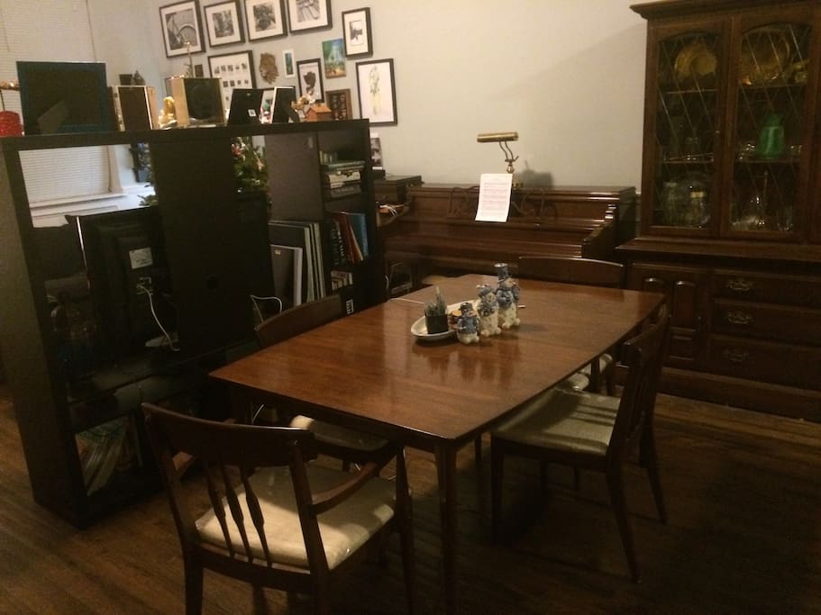 A dining table that seats 6 and a piano for after dinner sing-alongs