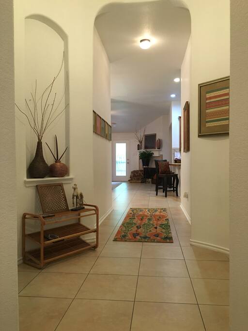 Greeting you as you open the front door is the open, airy hallway.