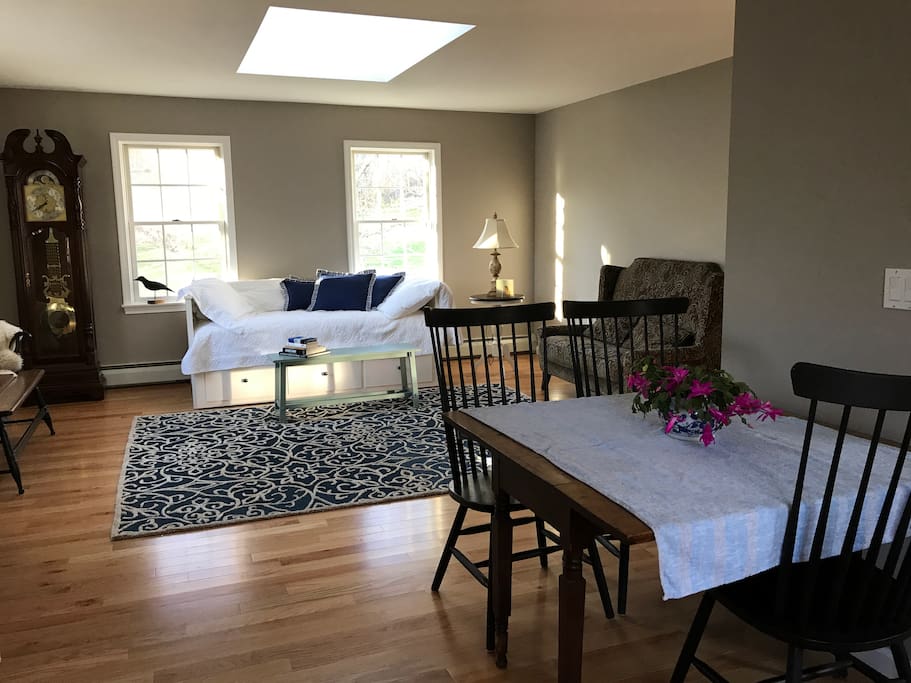 Spacious and open living room with skylight and lots of windows. Newly renovated with fresh paint and hardwood floors.