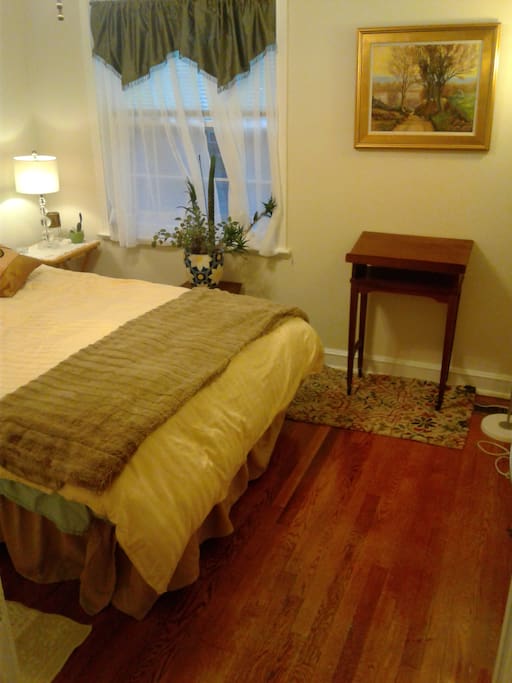 Beautiful hardwoods & original artwork in bedroom