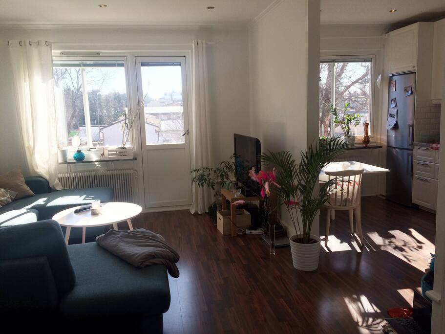 Livingroom with flatscreen TV and part of kitchen