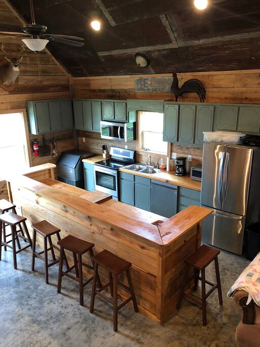 Kitchen with industrial ice maker, dishwasher, washer and dryer.