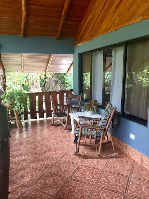 Second floor balcony surrounded by jungle.
