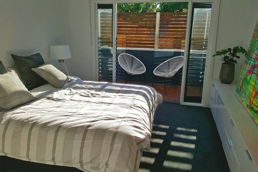 Main bedroom with balcony and king size bed