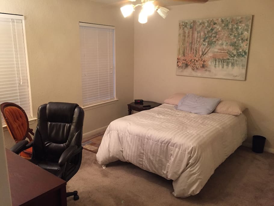 Room with full size bed and goose down comforter with walk in closet.