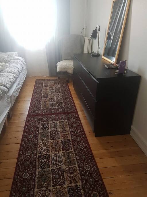 The smaller room with two single beds.
