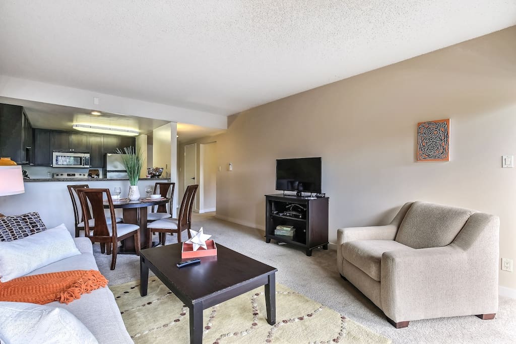Living room with view into kitchen and dining area