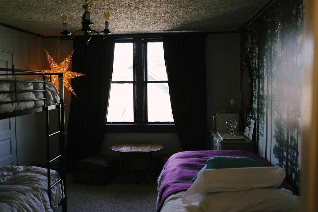 The other two beds are bunk beds on the opposite side of the room.