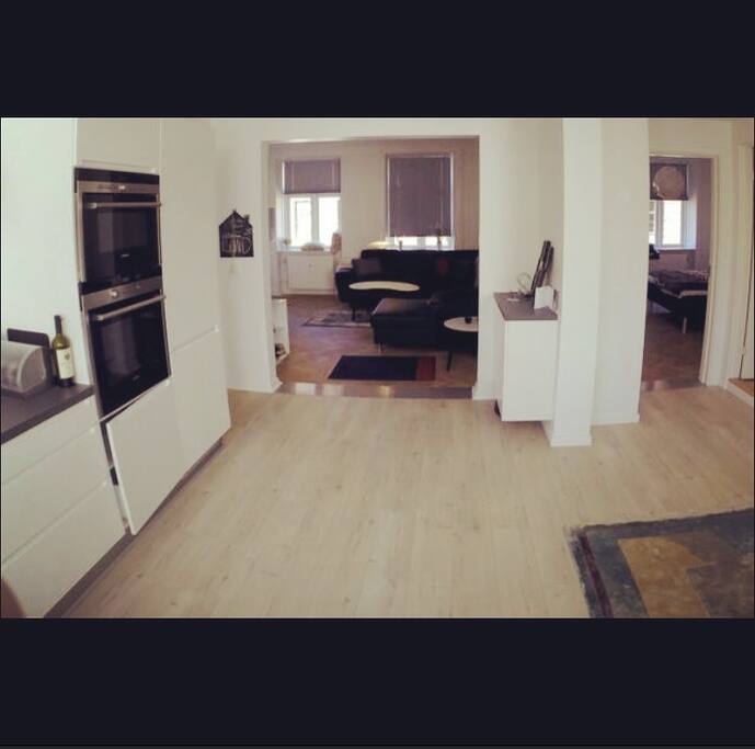 View from the kicthen towards the livingroom and one of the bedrooms. Bathroom is on the right.