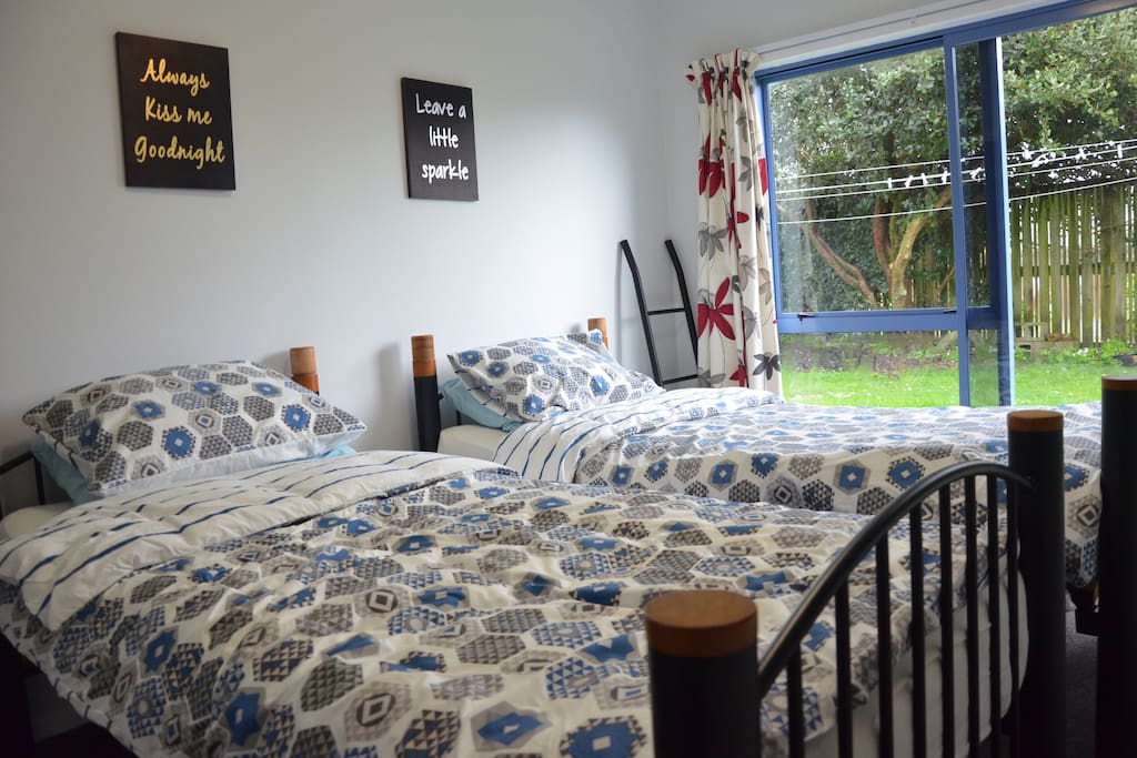 Room #1 with two single beds, desk and garden access