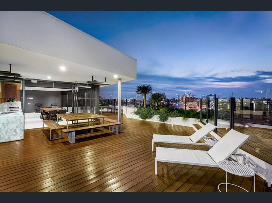 Roof top entertainment area with dining and TV room.