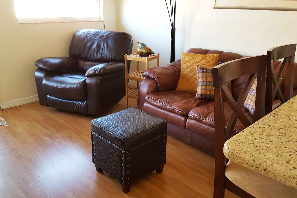 Living room area is tastefully decorated. Wood laminate floors are installed throughout the condo with the exception of the bathroom which has tile.
