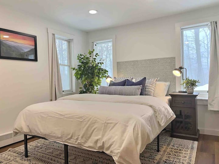 Find serenity in our queen bedroom, with stunning forest views.