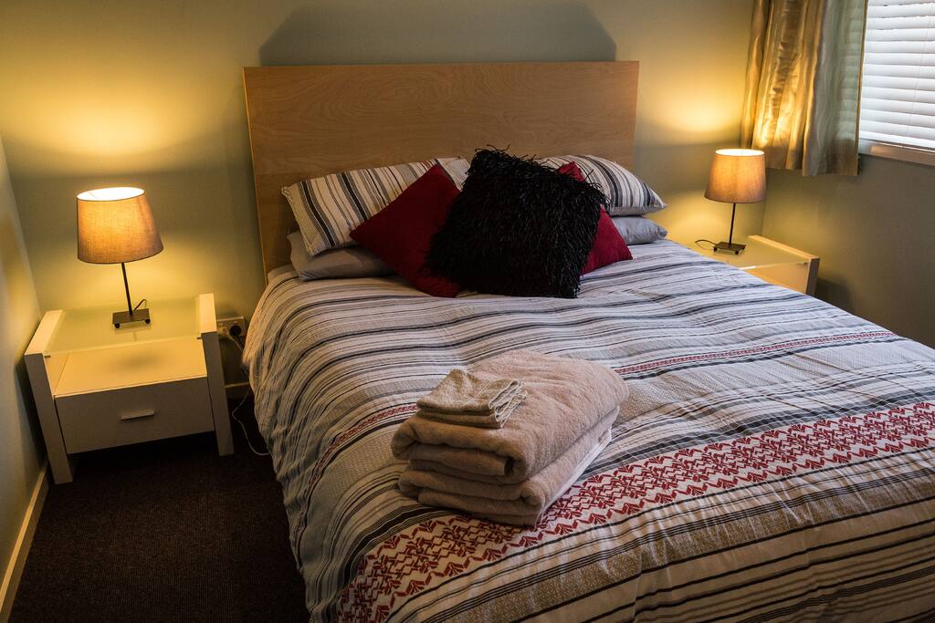 Bedroom with queen bed, doona, linen changed regularly, new side-tables and built-in-robe.