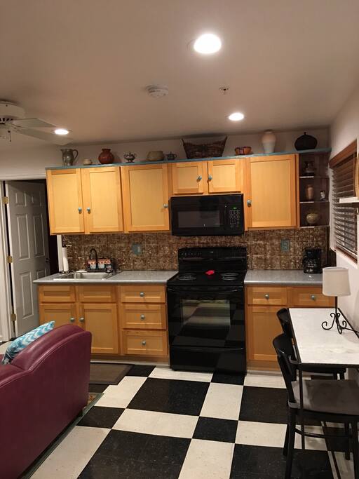 View from the door. Full size stove, microwave, & refrigerator
