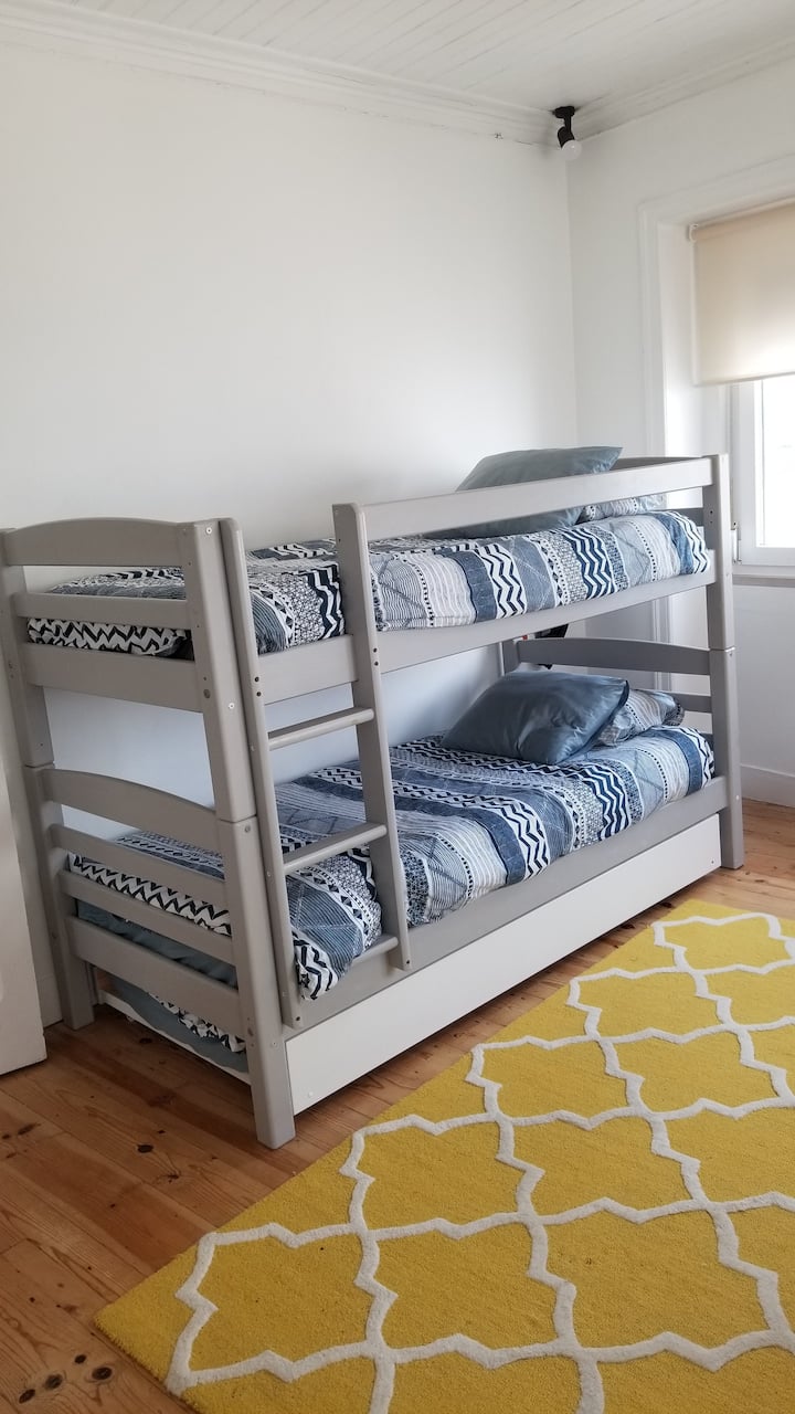 Bedroom with bunk bed and drawer bed for a third person.
