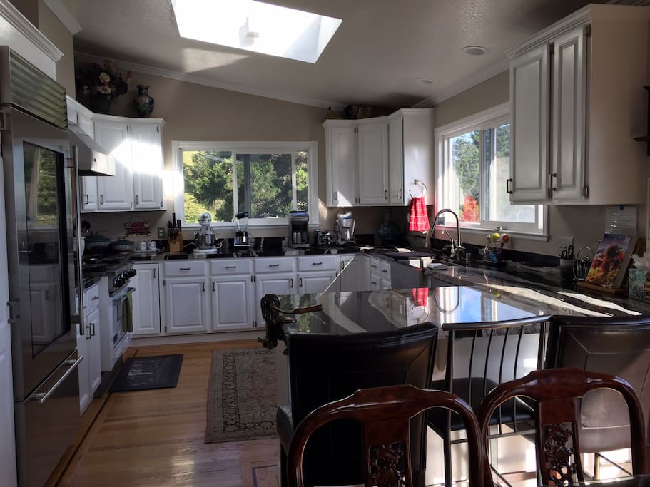 Large Kitchen with view of the ocean and trees, subzero ref and viking gas stove/oven