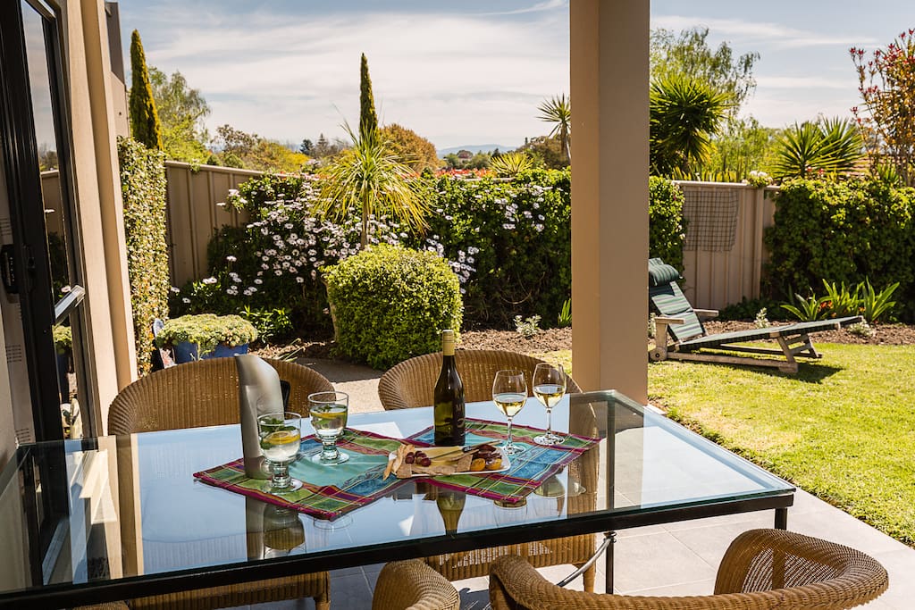 Large table under cover - have a barbeque if you want. Sunny garden