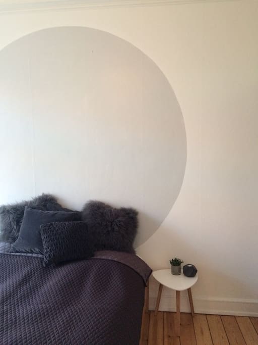 A comfy bed, a mirror, and a big white closet space