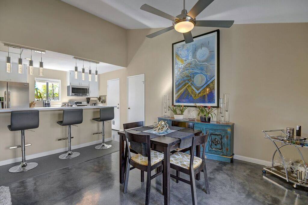 Dining area features seating for 4 and 3 at the breakfast bar