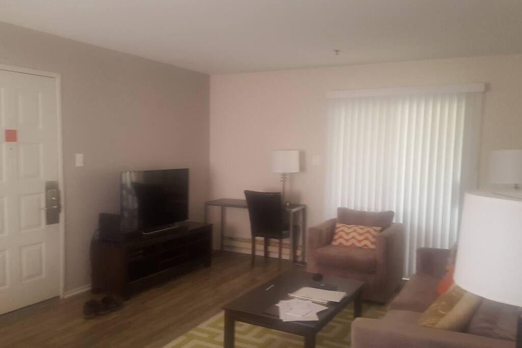 Shared room with bed, TV, and couch.