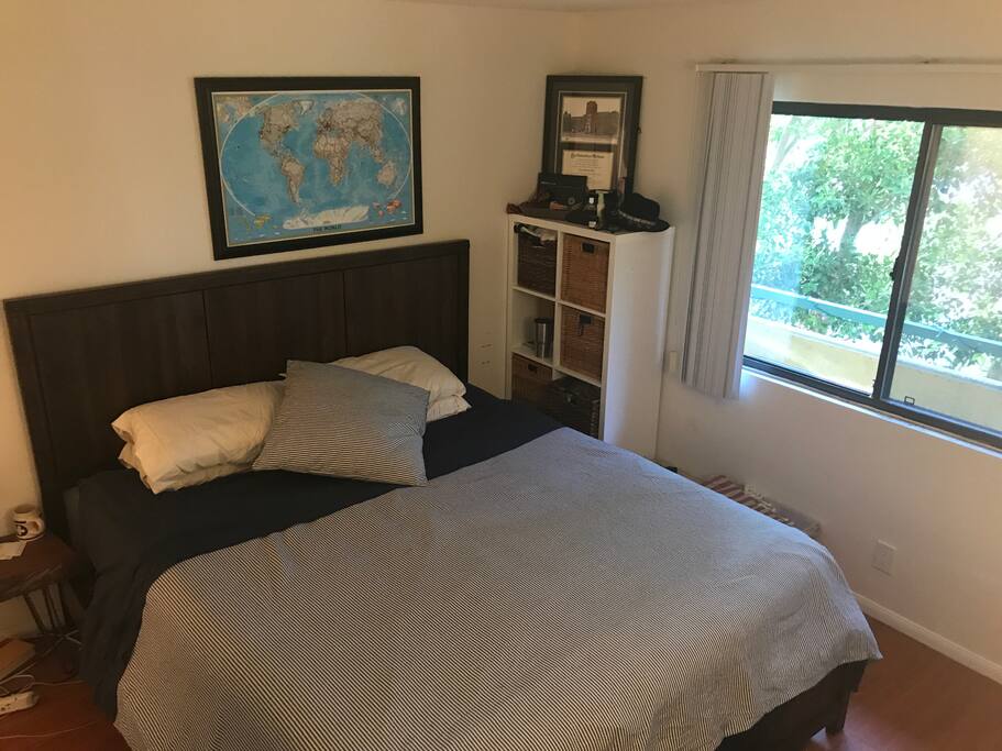Master Bedroom with Cal King + Mounted TV at foot of bed
