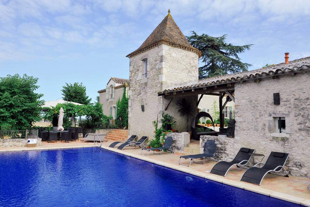The medieval tower, "Pigeonette" in French, and terraces as seen from the pool