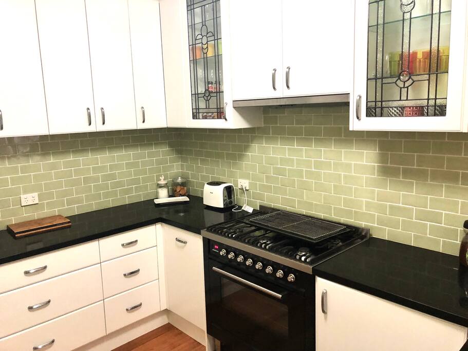 Stylish modern kitchen with integrated fridge/freezer, microwave and washer/dryer.
