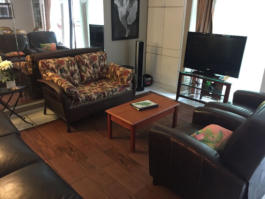 Comfortable living room with reclining leather furniture and Flat Screen TV