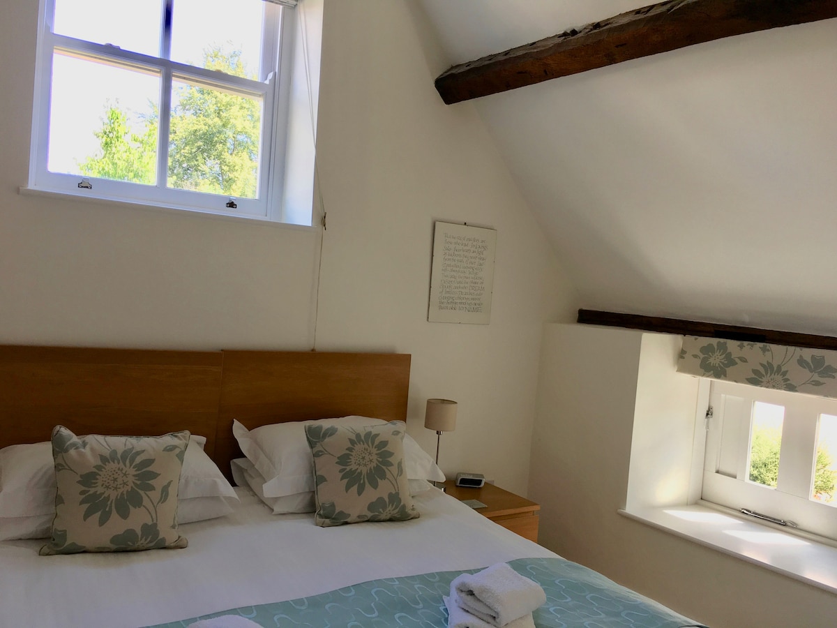 Once a hay loft now a bedroom with supering comfy bed, lofty original beams and an ensuite