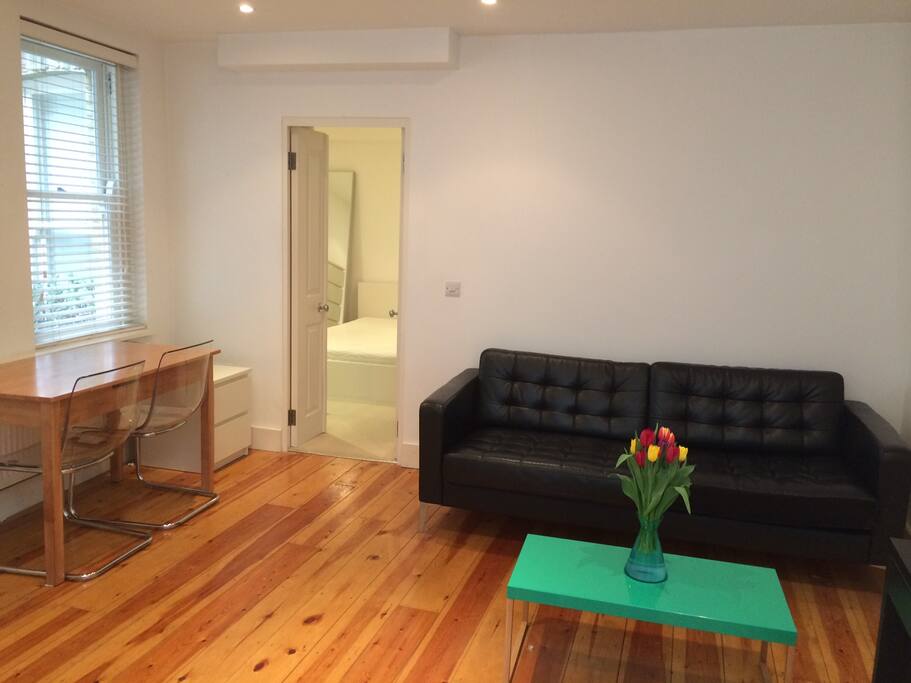 The sitting room has a table to eat at and leads onto the bedroom