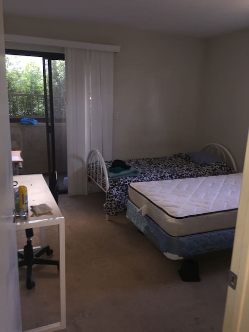 The bedroom. It contains two twin sized beds along with two desks, which guests can also use.