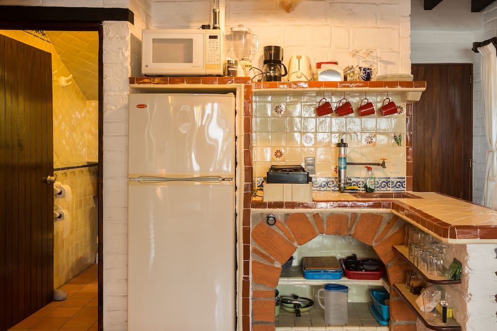 Functional kitchen area with coffee machine, blender, hotplate...