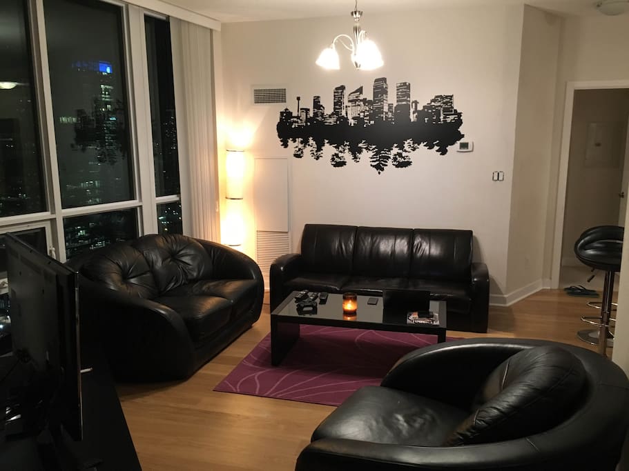 A classy living room area with ultra chic furniture and 3D television.