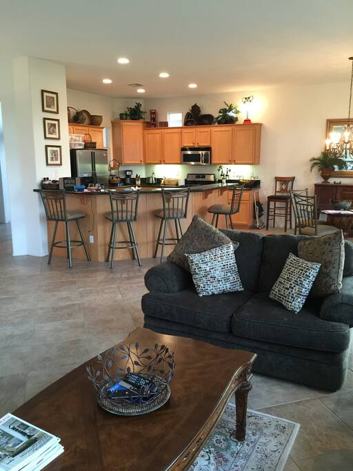 Kitchen and bar open to living room and dining room